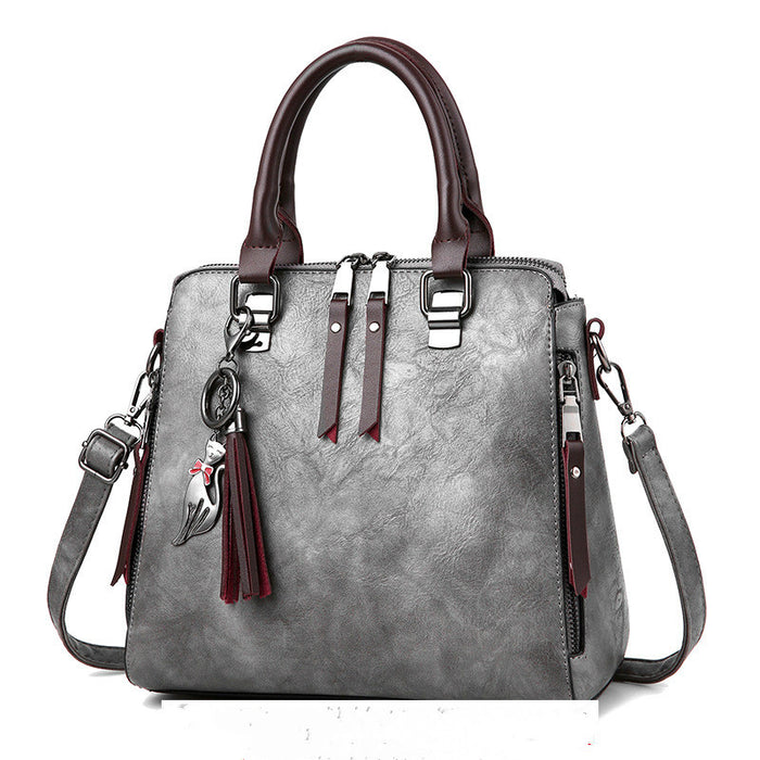 Fenna | Vintage handtas met kwastje en afneembare schouderriem