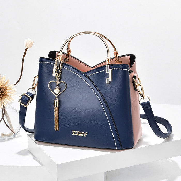 Fenna | Colour block handtas met hartje en schouderband